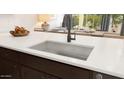 Granite countertop showcasing a stainless steel undermount sink and a stylish faucet in a modern kitchen setting at 23404 W Burton Ave, Buckeye, AZ 85326
