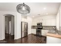 Well-lit kitchen features stainless steel appliances, white cabinets, and sleek countertops at 2554 E Vermont Dr, Gilbert, AZ 85295