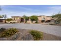 A charming single-story home featuring a lush, landscaped front yard and a circular paver driveway at 2727 S Balboa Dr, Gilbert, AZ 85295