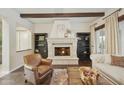 A beautifully appointed living room with a stone fireplace, hardwood floors and built in bookshelves at 2727 S Balboa Dr, Gilbert, AZ 85295