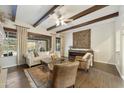 The living room is decorated with hardwood floors, wood ceiling beams, and stylish neutral furniture at 2727 S Balboa Dr, Gilbert, AZ 85295