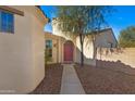 Inviting front entrance with desert landscaping and a pink front door at 29798 N 121St Dr, Peoria, AZ 85383