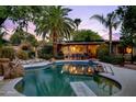 Inviting backyard pool area with lounge chairs and palm trees in a private setting at 3146 W Paradise Dr, Phoenix, AZ 85029