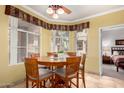 Bright dining area with a round wood table, seating for six, and natural light from the window at 3830 E Lakewood Pkwy # 1057, Phoenix, AZ 85048