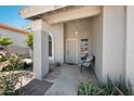 Charming front porch with decorative columns and a cozy seating area with a chair at 4319 E Tanglewood Dr, Phoenix, AZ 85048