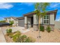 Beautiful single-story home with stone accents, a two-car garage, and xeriscaping with lush landscaping at 4701 S Siphon Draw Rd, Apache Junction, AZ 85119