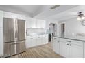 Bright kitchen featuring modern stainless steel appliances, stylish wood floors, and white cabinetry at 4815 W Charleston Ave, Glendale, AZ 85308