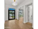 Bright entryway featuring hardwood floors, a modern light fixture, and stylish front door at 4911 E Amelia Ave, Phoenix, AZ 85018