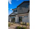 Close up of modern style, two-story home with professional landscaping and large windows at 4911 E Amelia Ave, Phoenix, AZ 85018