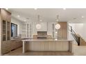 Gourmet kitchen featuring a large center island, custom cabinets, and pendant lighting at 4911 E Amelia Ave, Phoenix, AZ 85018