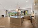 Open concept kitchen with island, hardwood floors, fireplace and backyard views at 4911 E Amelia Ave, Phoenix, AZ 85018