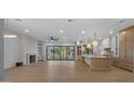 Open-concept living area with hardwood floors, fireplace, and modern kitchen island at 4911 E Amelia Ave, Phoenix, AZ 85018