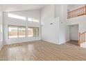Bright living room featuring wood-look tile floors, high ceilings, and ample natural light at 5123 W Novak Way, Laveen, AZ 85339
