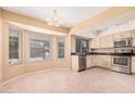 Spacious kitchen with stainless steel appliances, tile floors, and large bay windows overlooking the backyard at 6101 W Sunnyside Dr, Glendale, AZ 85304