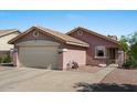 Lovely single-story home with a spacious two-car garage, low maintenance landscaping, and desert-style front yard at 612 E Racine Pl, Casa Grande, AZ 85122