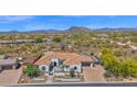 Aerial view of a beautiful home with desert landscaping and views of mountains at 6320 E Gloria Ln, Cave Creek, AZ 85331