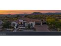 Stunning home with desert landscaping, mountain views, arched windows, three car garage, and a charming front courtyard at 6320 E Gloria Ln, Cave Creek, AZ 85331