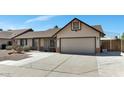 Single-story home with desert landscaping, covered entry, and a two-car garage at 6457 E Encanto St, Mesa, AZ 85205