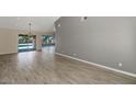 Open-concept living space with hardwood floors and views of the outdoor pool at 6457 E Encanto St, Mesa, AZ 85205