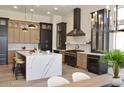 Kitchen with white walls, light floors, island with white countertop, and a black chandelier above the adjacent dining table at 6931 E Teton Cir, Mesa, AZ 85207
