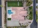 Overhead shot of a large home with a manicured lawn, pool, and landscaped grounds in a serene setting at 7129 E Caron Dr, Paradise Valley, AZ 85253