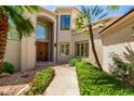 Inviting home exterior with manicured garden path leading to a grand entrance, showcasing classic architectural details at 7475 E Gainey Ranch Rd # 4, Scottsdale, AZ 85258