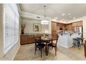 Charming dining area featuring a modern light fixture, adjacent to the kitchen, creating a seamless flow at 7601 E Indian Bend Rd # 1049, Scottsdale, AZ 85250