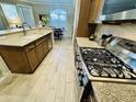 Well-lit kitchen featuring granite countertops, stainless steel appliances, and wood cabinets at 7601 E Indian Bend Rd # 1049, Scottsdale, AZ 85250