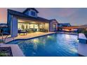 Beautiful backyard featuring a refreshing pool and a covered patio with outdoor dining furniture at 8138 E Jacaranda St, Mesa, AZ 85207