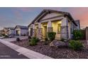 Charming home with well-maintained landscaping, stone accents, and inviting front porch at 8138 E Jacaranda St, Mesa, AZ 85207