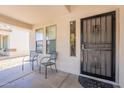 Covered front porch with two chairs and a decorative security door at 9352 W Pioneer St, Tolleson, AZ 85353