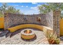 Cozy outdoor firepit area with custom brickwork and seating, perfect for entertaining at 9415 N 124Th St, Scottsdale, AZ 85259