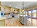 Spacious kitchen boasts custom cabinets, a large island, and stainless steel appliances at 9415 N 124Th St, Scottsdale, AZ 85259