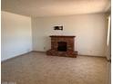 Open living room featuring a brick fireplace and neutral tile flooring at 9679 W Cinnabar Ave # B, Peoria, AZ 85345