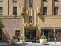 Exterior of building entrance with vintage art deco architecture and beautiful details in tan stone at 114 W Adams St # 907, Phoenix, AZ 85003