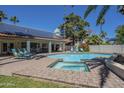 Sparkling pool with a spa, patio lounge chairs, and solar panels at 12537 N 76Th Pl, Scottsdale, AZ 85260