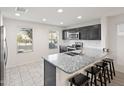 Stylish kitchen features granite counters, stainless appliances, and a breakfast bar with seating at 1255 N Banning --, Mesa, AZ 85205