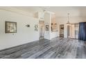 Bright living room boasts vaulted ceilings, a ceiling fan, and modern gray wood flooring at 14300 W Bell Rd # 261, Surprise, AZ 85374