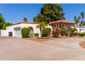 Single-story home featuring a circular driveway, two-car garage and mature landscaping at 14828 N Skokie Ct, Phoenix, AZ 85022