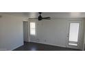 Well-lit room featuring a modern ceiling fan, clean white walls, and a gray wood-look floor at 1526 W Huntington Dr, Tempe, AZ 85282