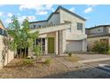 View of the home's exterior, highlighting the modern architectural features, desert landscaping, and inviting entryway at 16027 N 74Th Ln, Peoria, AZ 85382