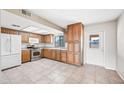 Kitchen showcasing tile flooring, stainless steel appliances and wooden cabinets at 1827 W Bluefield Ave, Phoenix, AZ 85023