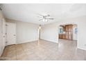 Living room featuring tile flooring, a ceiling fan and an open archway at 1827 W Bluefield Ave, Phoenix, AZ 85023
