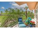 Relaxing balcony with lounge chair offers serene views of trees and blue sky at 2201 N Central Ave # 3D, Phoenix, AZ 85004