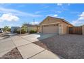 Single Gathering home showing large driveway, desert landscaping, and side gate at 3027 W Red Fox Rd, Phoenix, AZ 85083