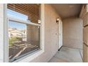 Close up of front porch with security door, a window with blinds, and an outdoor light fixture at 3027 W Red Fox Rd, Phoenix, AZ 85083