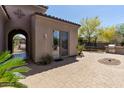 Outdoor space featuring brick pavers, a built-in grill, and access to the home's interior at 30434 N Palo Brea Dr, Scottsdale, AZ 85266