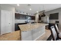 Modern kitchen with a spacious center island, stainless steel appliances, and granite countertops at 31006 W Weldon Ave, Buckeye, AZ 85396