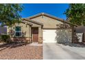 Single-story home with a well-maintained front yard and attached two-car garage at 36203 N Urika Dr, San Tan Valley, AZ 85140