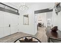 Elegant foyer with double doors, statement lighting, designer rug and decor at 38953 N 57Th Pl, Cave Creek, AZ 85331